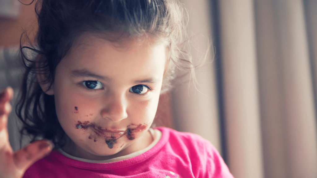 criança com a boca suja de chocolate